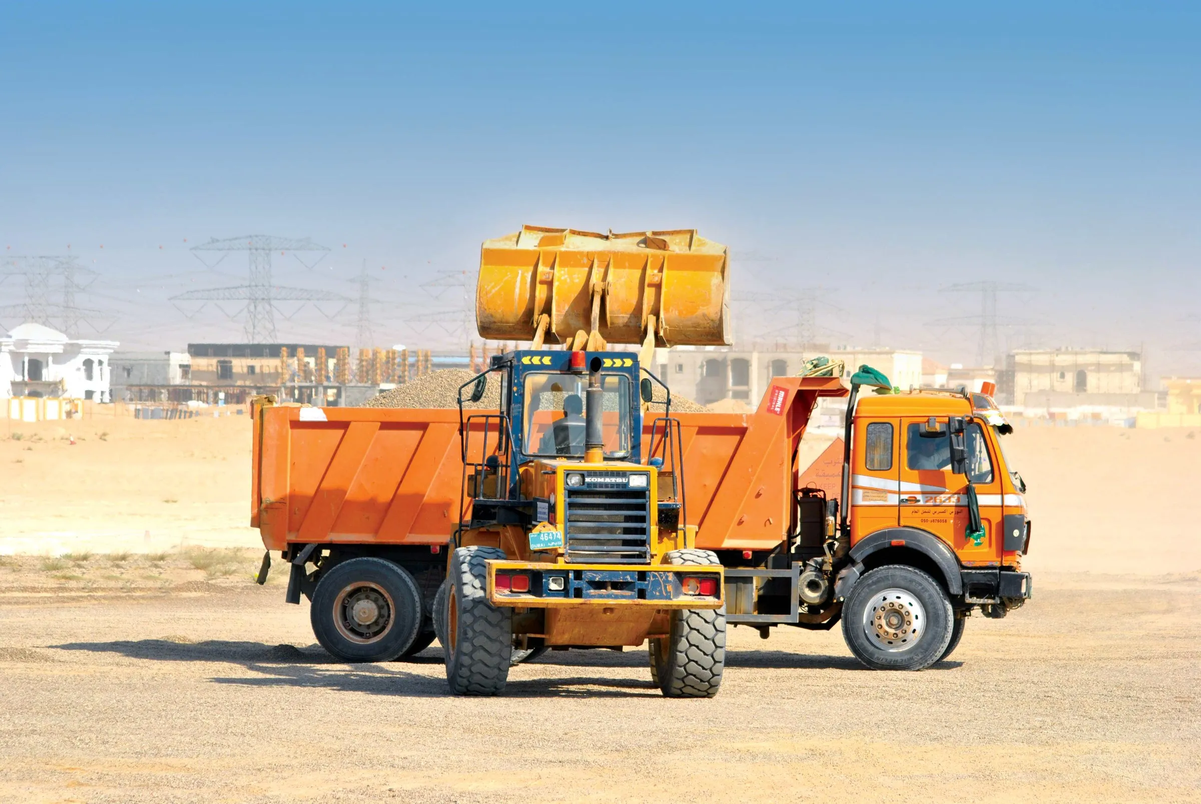 EEM loading truck at a construction site
